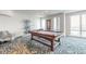 Spacious game room with a pool table, seating area, and large windows offering natural light and views at 3703 S Atlantic Ave # 501, Daytona Beach Shores, FL 32118