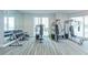 Bright gym with complete exercise equipment set including dumbbells and nautilus machines overlooking ocean at 3703 S Atlantic Ave # 501, Daytona Beach Shores, FL 32118
