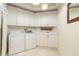 Laundry room with white cabinets, sink, and a washer and dryer set at 3703 S Atlantic Ave # 501, Daytona Beach Shores, FL 32118