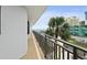 Balcony with ocean view, pool view, palm trees and metal railing at 2555 S Atlantic Ave # 207, Daytona Beach Shores, FL 32118