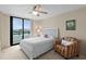 This stylish bedroom features ceiling fan and sunny balcony at 2555 S Atlantic Ave # 207, Daytona Beach Shores, FL 32118