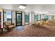 A clubhouse room featuring tables, chairs, and an exit to a patio overlooking the ocean at 2555 S Atlantic Ave # 207, Daytona Beach Shores, FL 32118