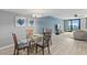 Dining room opens to living area and features beach-themed wall decor and seating for four at 2555 S Atlantic Ave # 207, Daytona Beach Shores, FL 32118