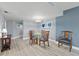 Dining room area features seating for four and modern decor with ocean-themed wall art at 2555 S Atlantic Ave # 207, Daytona Beach Shores, FL 32118
