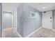 Hallway with neutral paint, base trim, and decorative artwork leading to main living areas at 2555 S Atlantic Ave # 207, Daytona Beach Shores, FL 32118