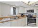 Modern kitchen with stainless steel appliances, tile flooring, and ample counter space at 2555 S Atlantic Ave # 207, Daytona Beach Shores, FL 32118