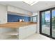 Kitchen/bar area adjacent to balcony, complete with cabinetry storage and wine glass rack at 2555 S Atlantic Ave # 207, Daytona Beach Shores, FL 32118