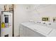 View of the laundry with a washer, dryer and water heater at 2555 S Atlantic Ave # 207, Daytona Beach Shores, FL 32118