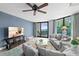 Bright living room features modern decor, ceiling fan, and sliding glass doors to a balcony with ocean views at 2555 S Atlantic Ave # 207, Daytona Beach Shores, FL 32118