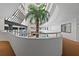 Expansive building atrium featuring a lush green tree extending to upper levels with a circular overlook at 2555 S Atlantic Ave # 207, Daytona Beach Shores, FL 32118