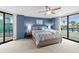 Cozy main bedroom featuring large bed and balcony access with an ocean view at 2555 S Atlantic Ave # 207, Daytona Beach Shores, FL 32118
