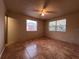 Bright bedroom featuring two windows with blinds and tile flooring at 1465 Wildrose Ln, Daytona Beach, FL 32117