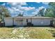 Back exterior of the house featuring a patio, sliding glass door, and a view of the backyard at 250 Hickory Ave, Orange City, FL 32763