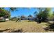 Expansive backyard featuring a playset, mature trees, and plenty of space for outdoor activities at 250 Hickory Ave, Orange City, FL 32763