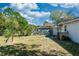 View of the backyard and exterior of the home, with mature trees and fencing for added privacy at 250 Hickory Ave, Orange City, FL 32763