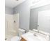 Bathroom with a shower, toilet, sink, vanity, mirror and white door at 250 Hickory Ave, Orange City, FL 32763