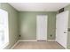 Spacious bedroom with tile floors, closet, and white doors, providing ample storage at 250 Hickory Ave, Orange City, FL 32763