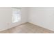 Well-lit bedroom with tile flooring, a window, and a fresh, neutral color palette at 250 Hickory Ave, Orange City, FL 32763