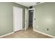 Bedroom featuring a closet and doorway, with tile flooring and light green walls at 250 Hickory Ave, Orange City, FL 32763