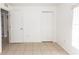 Bright bedroom with neutral walls, tile floors, and closet offers a serene and inviting space at 250 Hickory Ave, Orange City, FL 32763