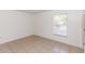 Bright bedroom with tiled floors, window with blinds and a neutral color scheme at 250 Hickory Ave, Orange City, FL 32763