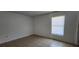 Bedroom with neutral walls, tile flooring, and a window offering natural light at 250 Hickory Ave, Orange City, FL 32763