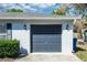 The home features a gray two-car garage with exterior lights, and a concrete driveway at 250 Hickory Ave, Orange City, FL 32763