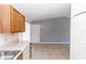 This functional kitchen flows into the living room and features light countertops and natural wood cabinets at 250 Hickory Ave, Orange City, FL 32763