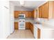 This functional kitchen features white appliances, light countertops, and natural wood cabinets at 250 Hickory Ave, Orange City, FL 32763