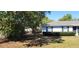 View of a side yard with mature trees, partial fencing and minimal grass at 250 Hickory Ave, Orange City, FL 32763