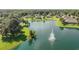 Aerial view of a house on a lake with fountain at 811 Grand Park Ct, Deland, FL 32724