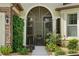 Inviting front entry with lush landscaping and screened porch at 9777 Sw 63Rd Loop, Ocala, FL 34481
