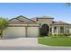 Beautiful house exterior with three-car garage and manicured lawn at 9777 Sw 63Rd Loop, Ocala, FL 34481