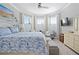 Bright main bedroom with king bed, seating area and large windows at 9777 Sw 63Rd Loop, Ocala, FL 34481