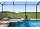 Relaxing pool and spa with a view of lush greenery at 9777 Sw 63Rd Loop, Ocala, FL 34481