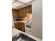 Functional kitchen with wood cabinets and white appliances at 110 Cypress Woods Ct # 7D, Deltona, FL 32725