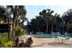 Community swimming pool with lounge chairs and tables at 110 Cypress Woods Ct # 7D, Deltona, FL 32725