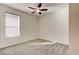 Bright bedroom with neutral carpet, a ceiling fan, and a window providing natural light at 112 Chelsea Place Ave, Ormond Beach, FL 32174