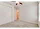 Bright bedroom featuring neutral carpet, fan, and a closet with sliding doors at 112 Chelsea Place Ave, Ormond Beach, FL 32174