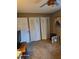 Carpeted bedroom includes bi-fold closet doors and a ceiling fan at 1461 N Felton St, Deltona, FL 32725