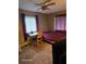 Carpeted bedroom features a desk, two windows, and comfortable furnishings at 1461 N Felton St, Deltona, FL 32725