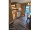Open kitchen and dining area with wood floors and a sliding glass door leading to the outdoors at 1461 N Felton St, Deltona, FL 32725
