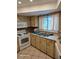 Kitchen features bright cabinets, white appliances, and a stainless-steel sink beneath a window at 1461 N Felton St, Deltona, FL 32725