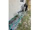 Side yard with pipes and equipment, showcasing home's efficient plumbing and irrigation setup at 1461 N Felton St, Deltona, FL 32725