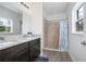 Bathroom featuring double sinks with granite countertops and a tiled walk-in shower at 2126 7Th Ave, Deland, FL 32724