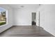 Bedroom with wood-look floors and a bright window overlooking the outdoors at 2126 7Th Ave, Deland, FL 32724