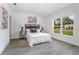 Bright bedroom with gray wood floors, large window, neutral walls and simple decor at 2126 7Th Ave, Deland, FL 32724