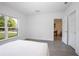 Bedroom with wood-look floors, white walls, and a bright window overlooking the lawn at 2126 7Th Ave, Deland, FL 32724