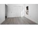 Bedroom with wood-look floors, white walls, closet, and natural light from the window at 2126 7Th Ave, Deland, FL 32724