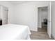 Bright bedroom featuring wood-look floors, white walls, and neutral decor at 2126 7Th Ave, Deland, FL 32724